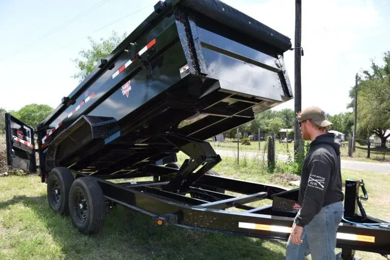 Cowboys Hauling dump trailer raised to unload a full haul.